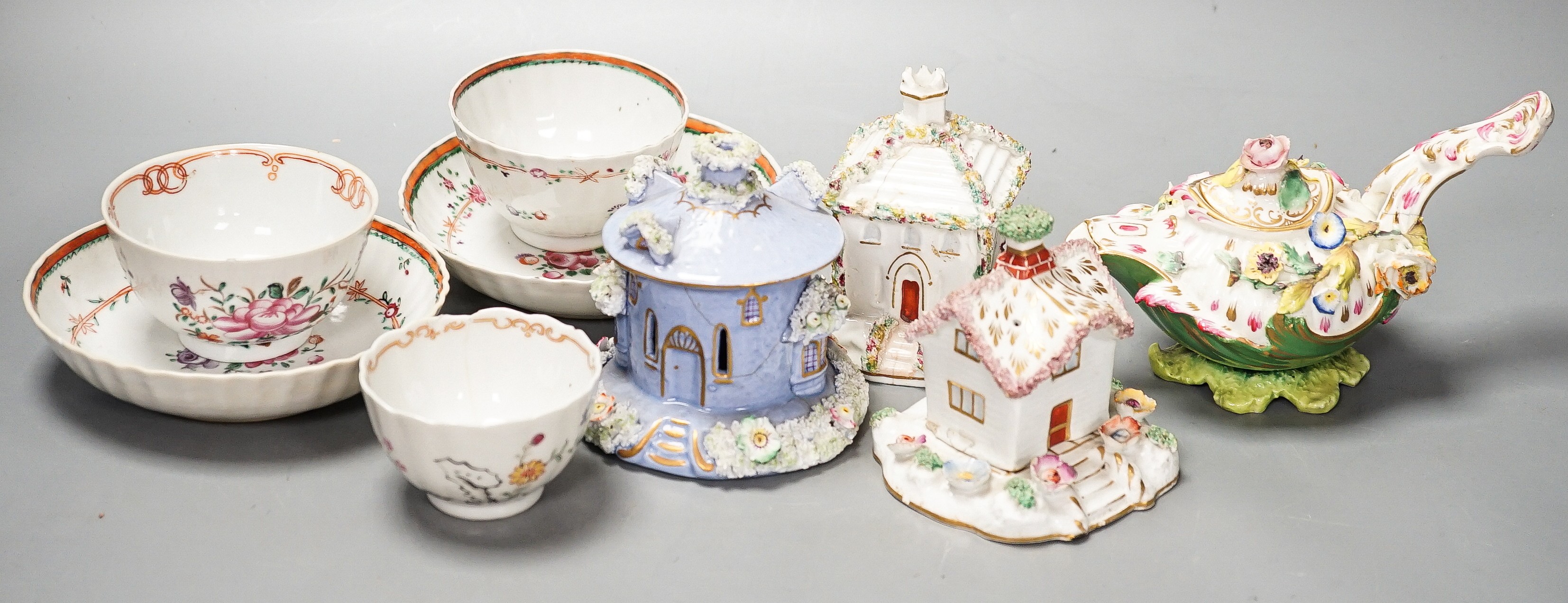 Three Chinese export famille rose tea bowls and two saucers, three Staffordshire porcelain cottage pastille burners and an English porcelain cream boat